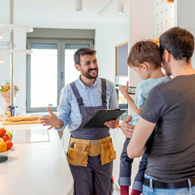 professional plumber talking to client