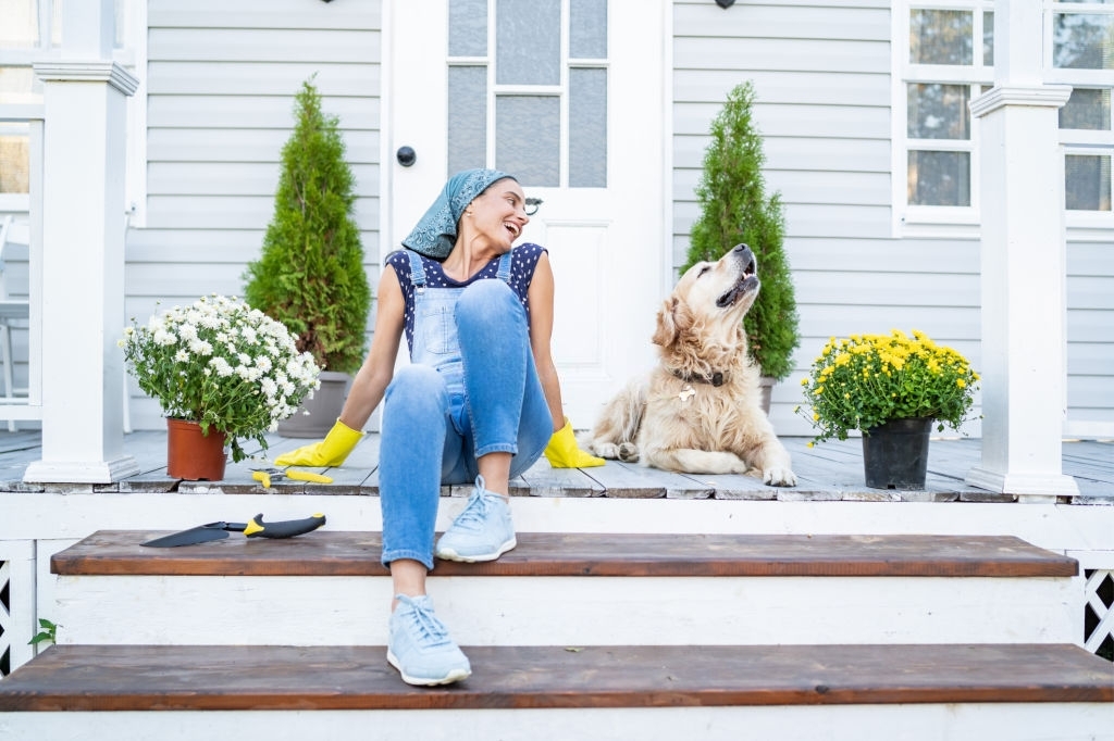 woman on porch of house